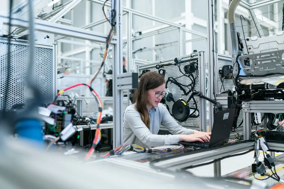 A researcher working at a laptop with reference material