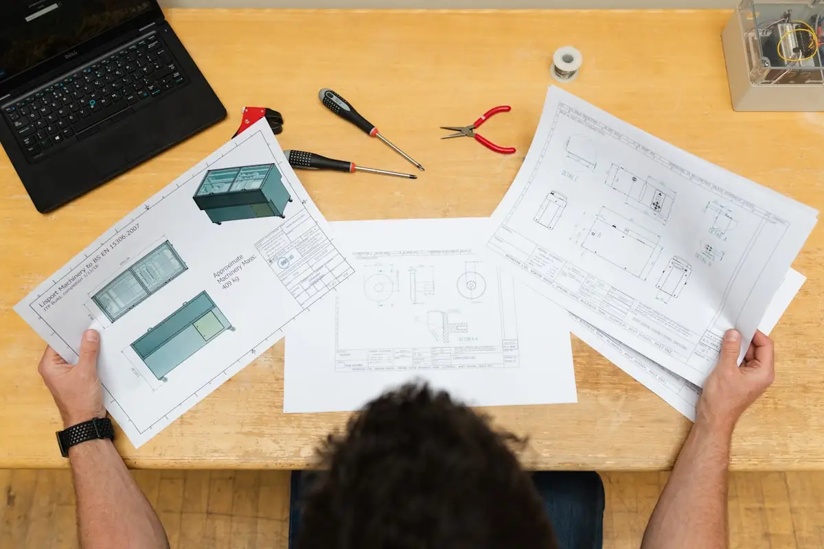 Technical drawings and notes on a working desk