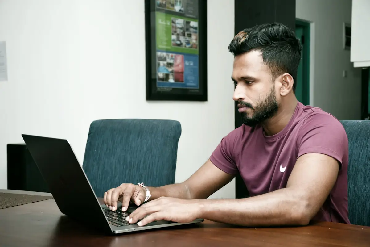 Someone working at a laptop in an office