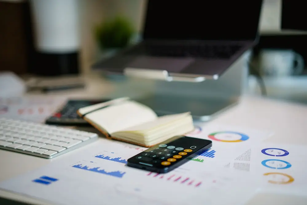 A desk with financial charts and reports under review