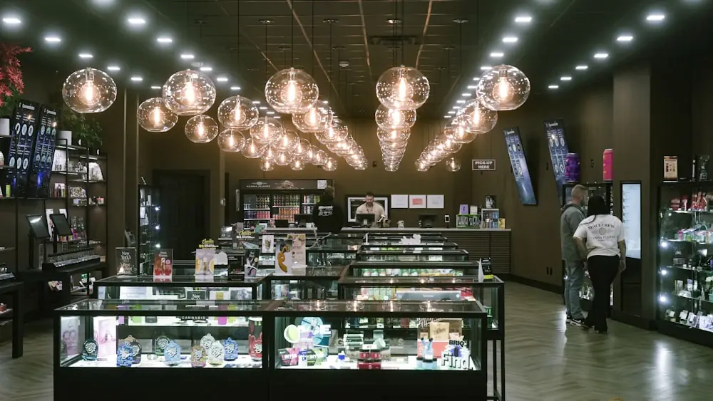 The interior of a modern retail store with lit product displays