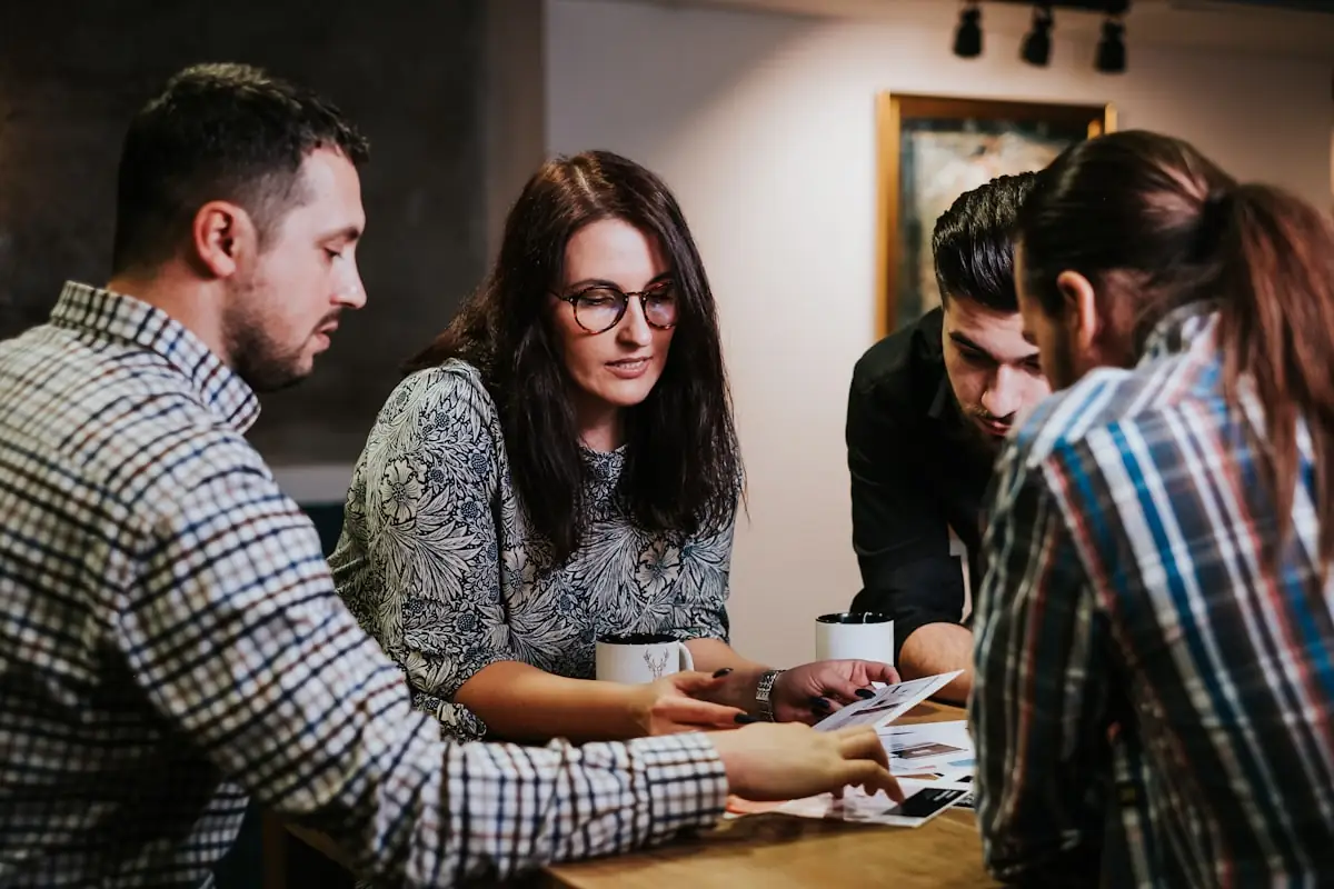 Colleagues reviewing documents around a table