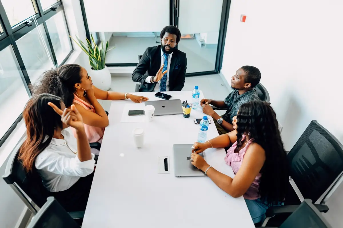 A group seated around a table in discussion
