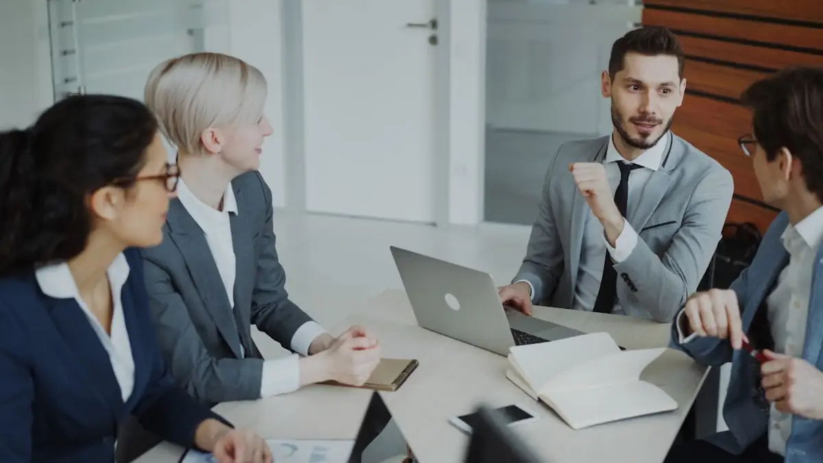Four colleagues in discussion around a conference table